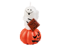 Halloween-Kerze mit einem Geist, der ein „Trick or Treat“-Schild hält und auf einem Kürbis sitzt.