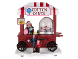 Weihnachtsdekoration mit Süßigkeitenwagen, „COTTON CANDY“-Schild und Figuren.