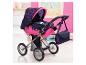 Dunkelblauer und pinker Puppenwagen mit Herzmuster und passender Tasche.