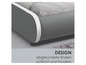 Ein graues Bett mit abgerundeten Ecken und weißen Details.