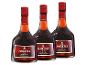 Drei Flaschen XO Solera Gran Reserva Brandy mit roten Etiketten.