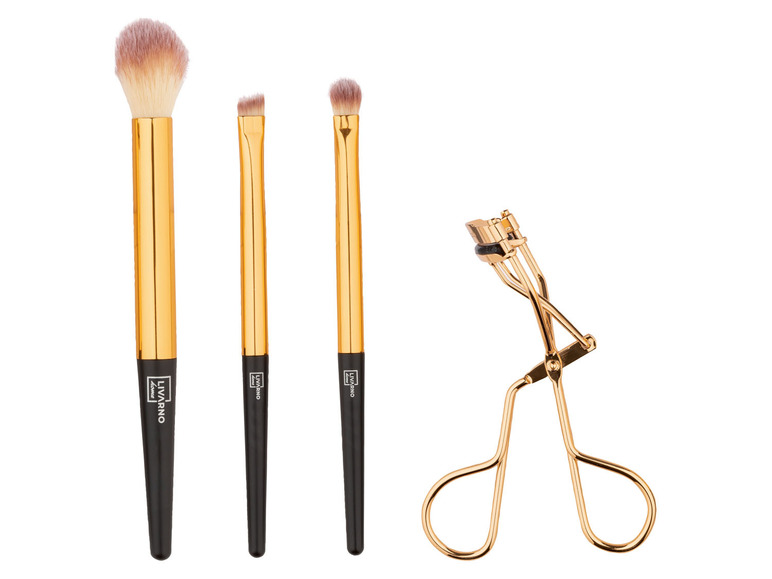 Ein Set mit drei goldenen Make-up-Pinseln und einer Wimpernzange von Livarno.