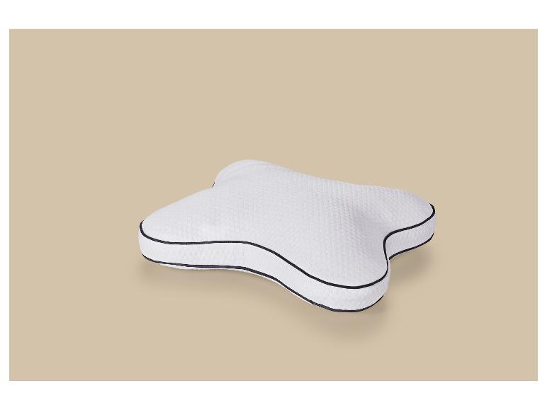 Weißes ergonomisches Kissen mit schwarzem Rand auf beigem Hintergrund