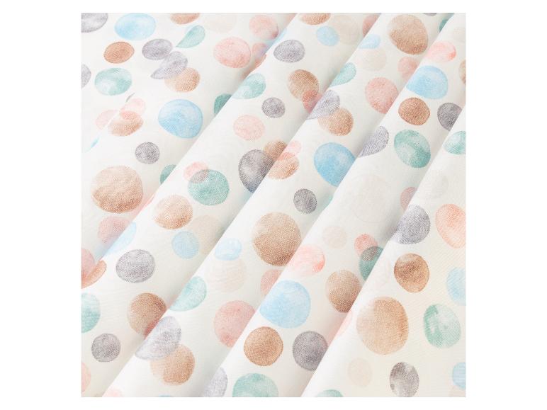 Stoff mit pastellfarbenen Punkten: Braun-, Blau- und Rosatöne.