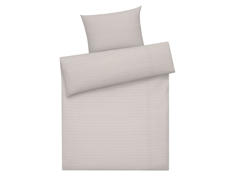 Beige Bettwäsche mit Zickzack-Muster.