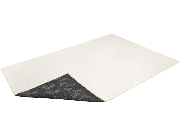 Weißer Teppich mit Wellenmuster und grauer rutschfester Rückseite mit Blättern.