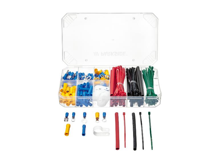 Set aus elektrischen Klemmen und Kabelbindern in einer transparenten Box, mit Text auf dem Deckel.