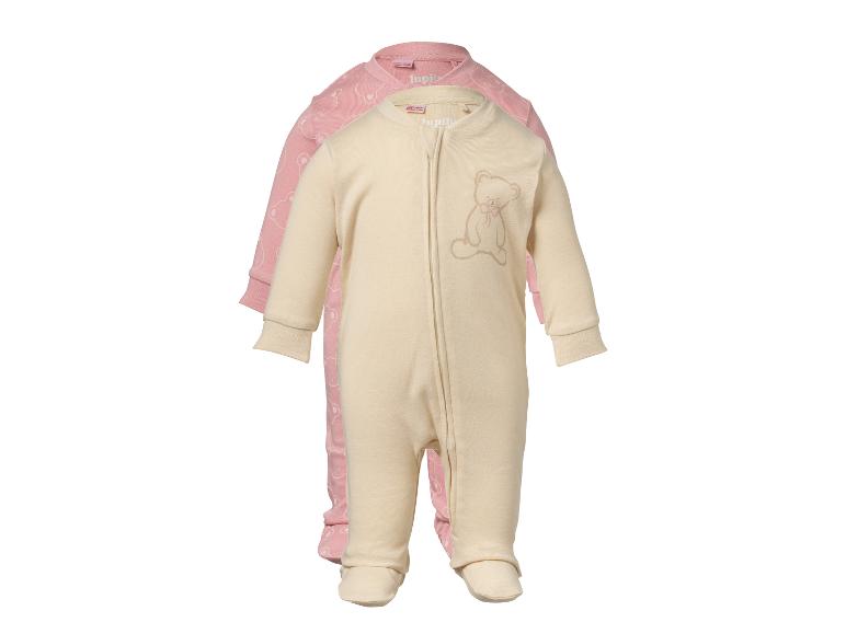 Zwei Baby-Schlafanzüge, einer cremefarben mit gesticktem Bären und einer rosa mit Bärenmuster.
