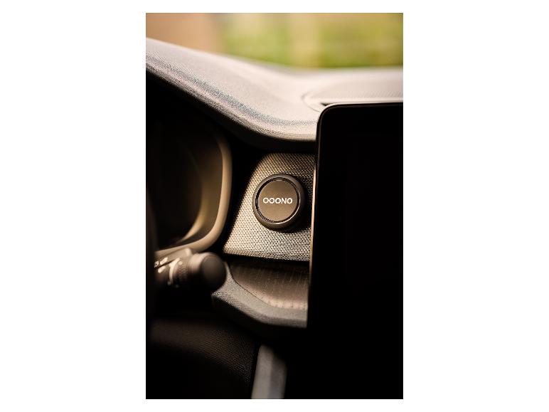 Schwarzer runder Knopf mit der Aufschrift „OOONO“ in einem Auto.