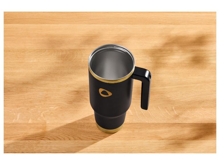 Schwarzer Thermobecher mit goldenen Akzenten auf einem Holztisch.