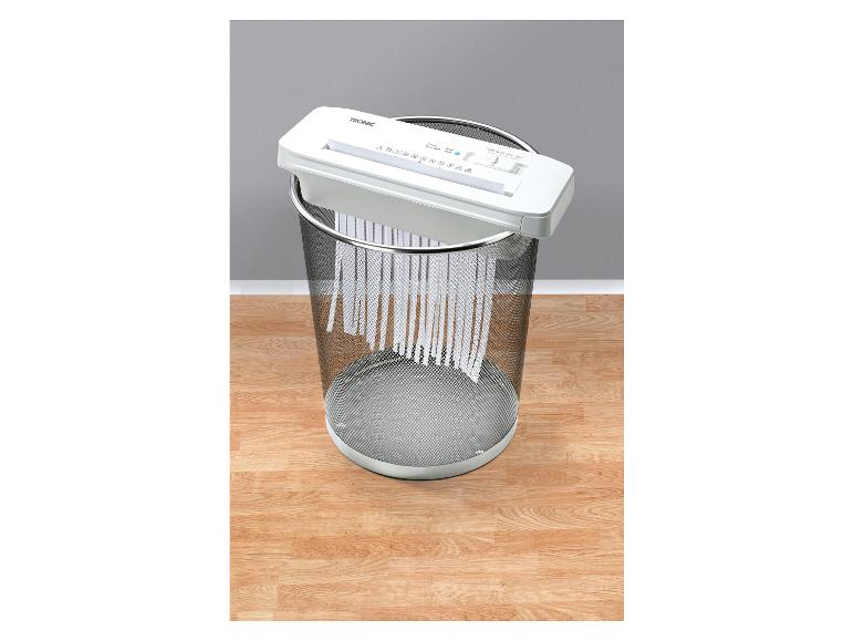 TRONIC Aktenvernichter auf einem Metall-Mülleimer, geschreddertes Papier fällt herunter.