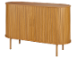 Ovaler Holzschrank mit Lamellentüren und vier Beinen.