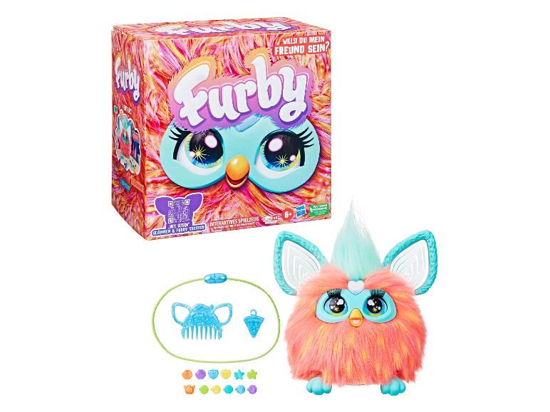 Interaktives Furby-Spielzeug mit Zubehör, inklusive Kamm und Perlen, in einer bunten Box.