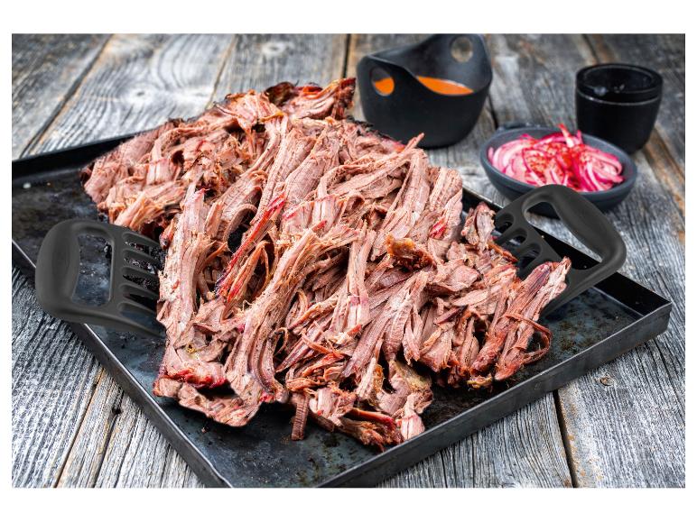 Pulled Meat mit Fleischgabeln, Sauce und eingelegten Zwiebeln.