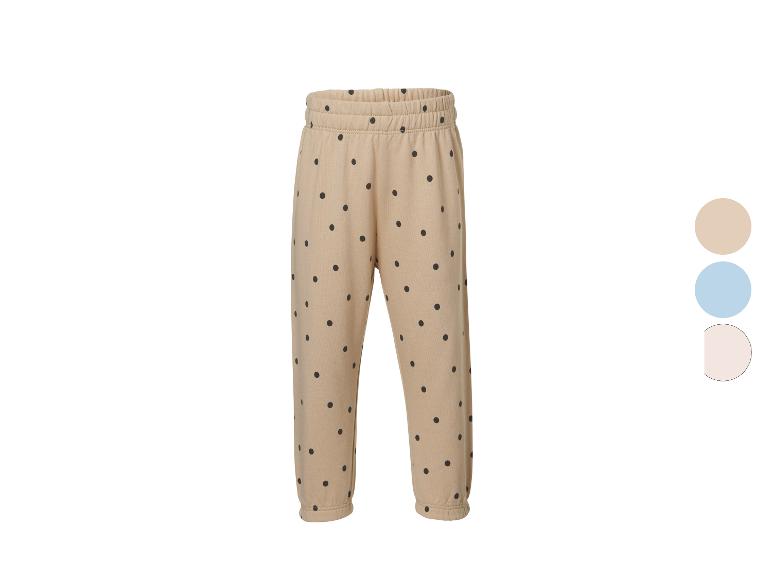 Beige Jogginghose mit schwarzen Punkten, elastischem Bund und Bündchen.