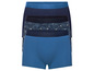 Drei blaue Boxershorts, eine mit tropischem Muster