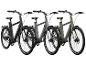 Drei E-Bikes in Schwarz, Grau und Grün.