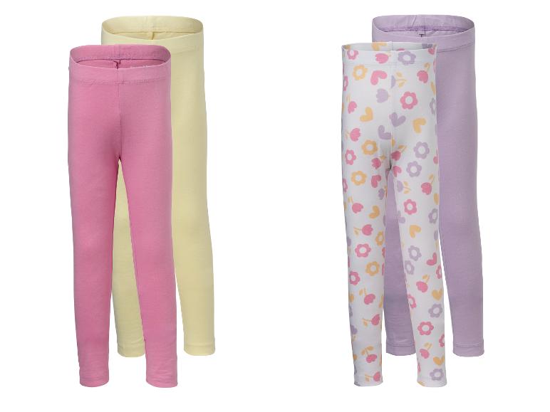 Zwei Paar Kinderleggings: pink und gelb, sowie weiß geblümt mit lila.