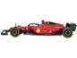 Rotes Spielzeug-Rennauto mit gelben Felgen und Sponsorenlogos auf schwarzem Hintergrund.