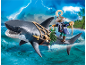 Spielzeugfigur eines Piraten, der auf einem großen Hai vor stürmischer See reitet.