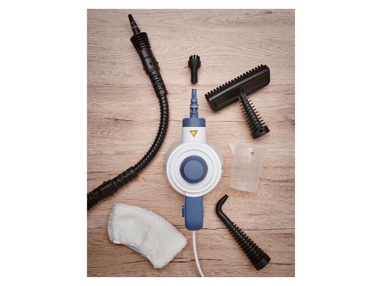 Handdampfreiniger mit verschiedenen Düsen, Messbecher und Reinigungstuch auf Holzoberfläche.