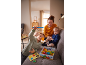 Mutter und Kinder spielen ein magnetisches Angelspiel aus Holz auf dem Sofa.