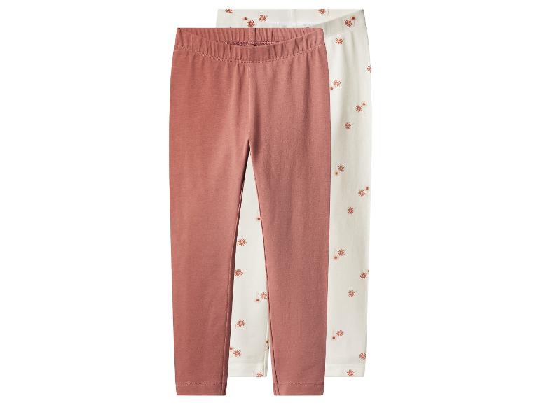Zwei Leggings für Mädchen: eine rosa und eine mit Blumen.