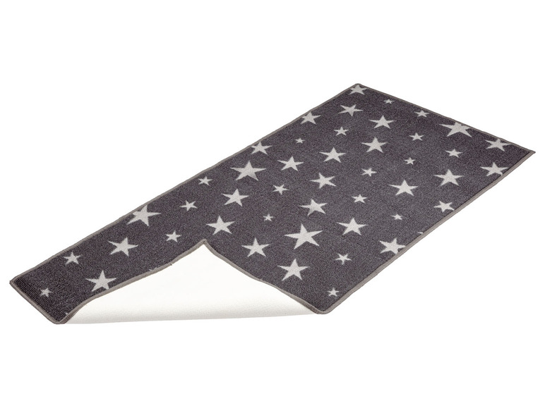 Eine graue Fußmatte mit weißen Sternen.