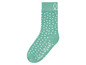 Eine grüne Socke mit weißen Punkten von By.S.Oliver.