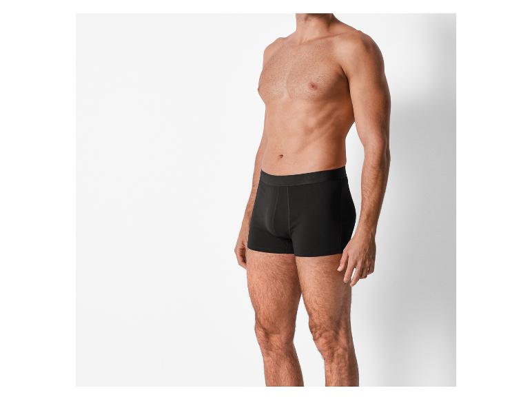 Ein Mann trägt schwarze Boxershorts.