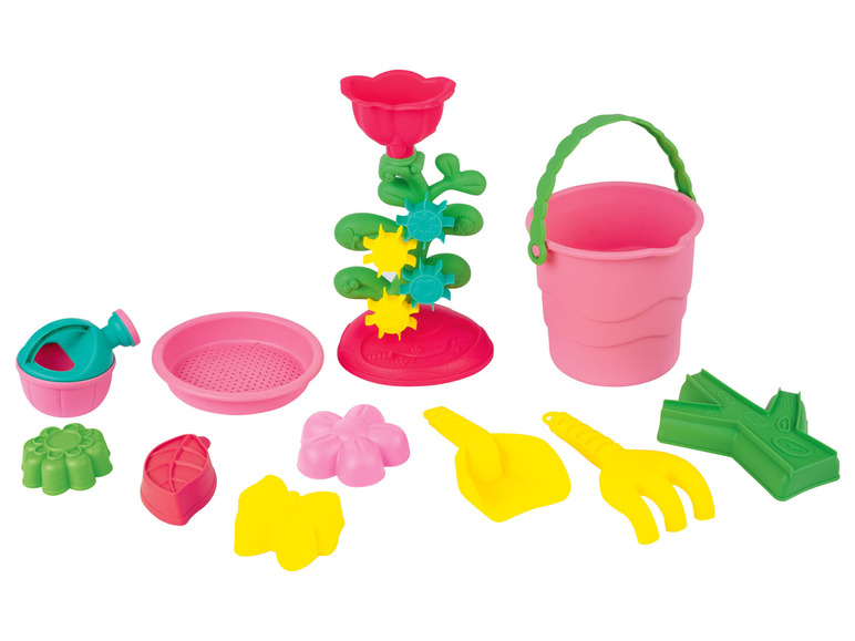 Ein rosa Eimer, eine Schaufel, eine Harke und ein Sandspielset mit Blumen.