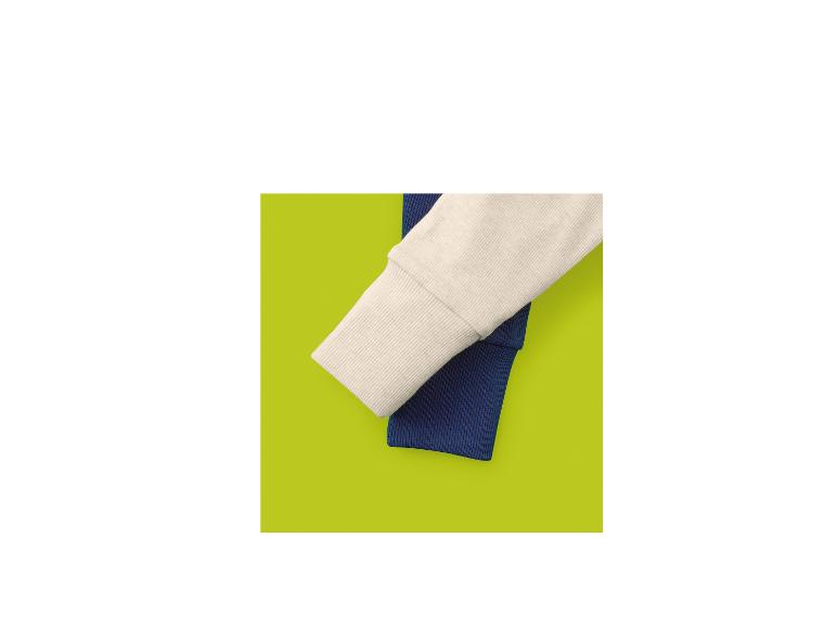 Zwei gerippte Ärmel, einer cremefarben und einer marineblau, auf limettengrünem Hintergrund.