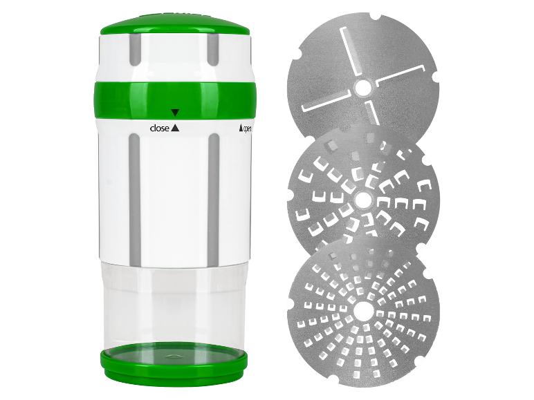 Grün-weiße Handreibe mit drei austauschbaren Reibscheiben.