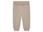 Beige Baby-Jogginghose aus meliertem Stoff.