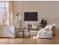 Modernes Wohnzimmer mit eleganten Möbeln, bequemen Sofas und einem wandmontierten Fernseher.