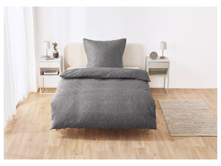 Graue Bettwäsche mit modernem geometrischen Muster.
