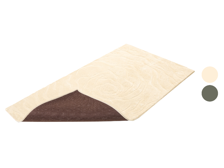 Beige Badematte mit Wellenmuster und rutschfester Unterseite.