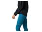 Frau in schwarzer Sportjacke und blauen Sportleggings mit Seitentaschen.