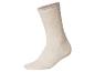 Beige Socke mit geripptem Bündchen.
