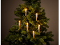 Künstlicher Weihnachtsbaum mit leuchtenden LED-Kerzen auf dunklem Hintergrund.
