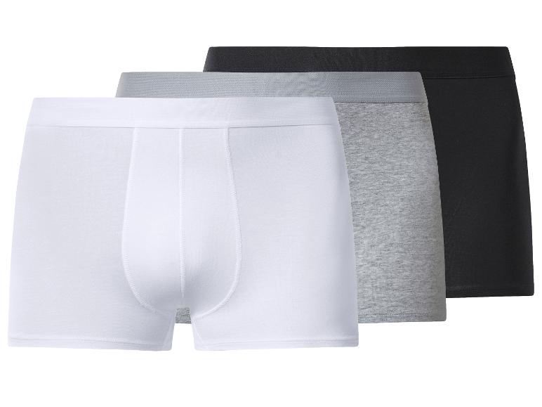Drei Herren-Boxershorts in Weiß, Grau und Schwarz.
