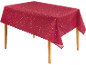 Rote Tischdecke mit weißem Sternenmuster auf einem Holztisch.
