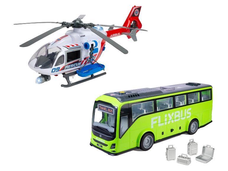 Spielzeug-Rettungshubschrauber und grüner Bus mit „TRAVEL BUS“-Schild und Gepäck.