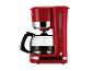 Rote Kaffeemaschine mit Glaskanne und beleuchtetem Einschaltknopf.