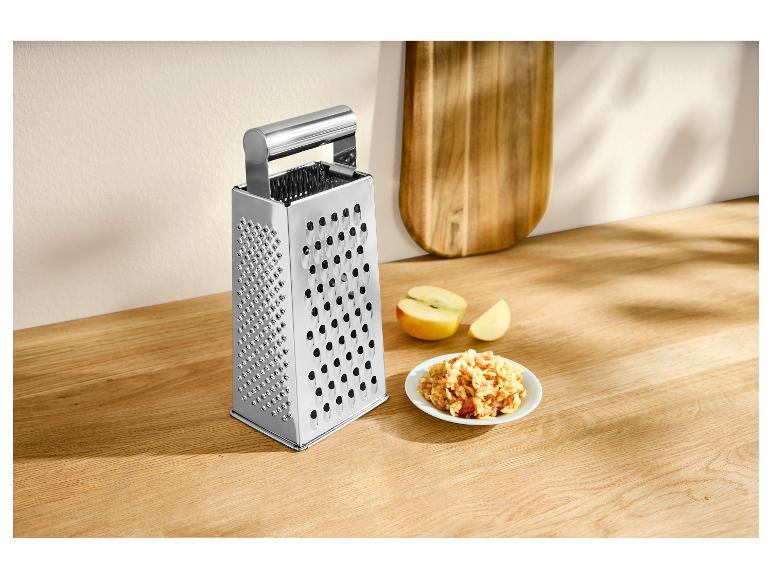 Vierkantreibe aus Edelstahl mit geriebenen Äpfeln auf einer Holzplatte.