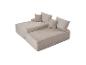 Zweiteiliges beiges Modulsofa mit Kissen, mit Cord-Textur.