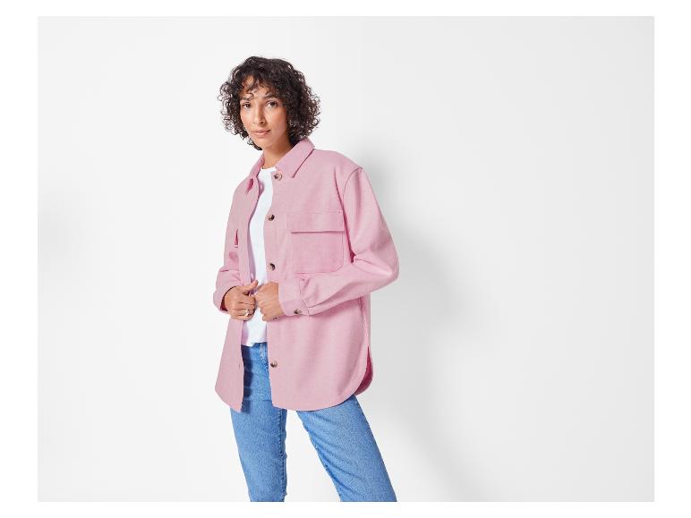 Eine Frau trägt eine rosafarbene Hemdjacke und blaue Jeans.
