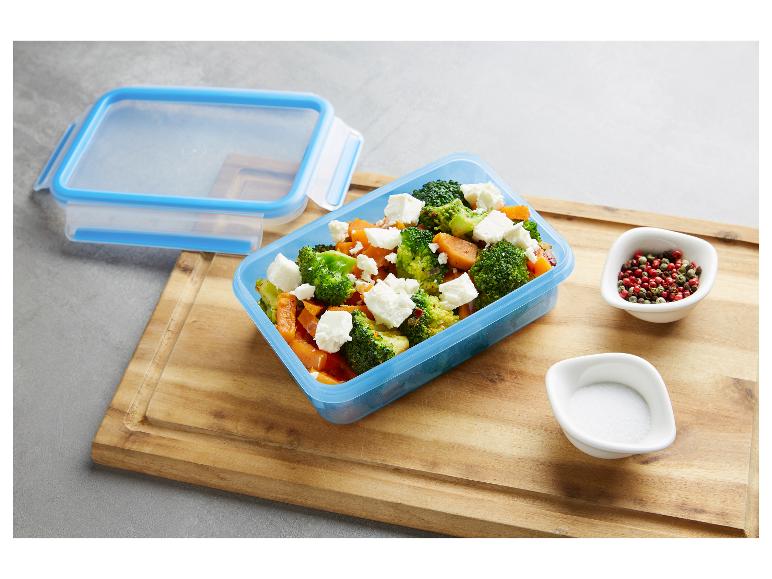 Blaue Frischhaltedose mit Brokkoli- und Süßkartoffelsalat mit Feta, Salz und Pfeffer.