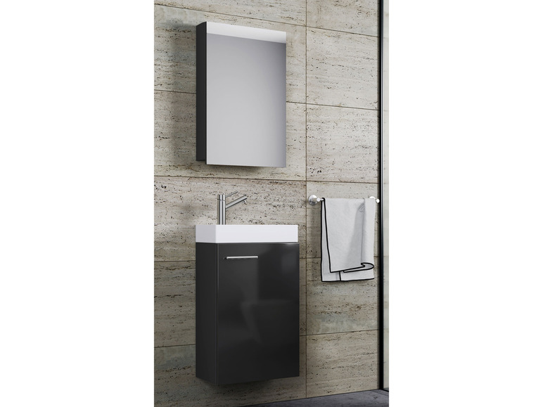 Ein schwarzer Badezimmerschrank mit Spiegel, Waschbecken und Handtuchhalter.
