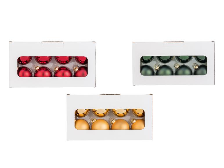 Drei Schachteln mit LIVARNO® Weihnachtskugeln in Rot, Grün und Gold.